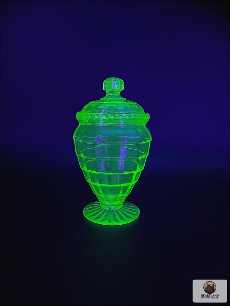 Hocking uranium glass lidded candy dish glowing green under ultraviolet light